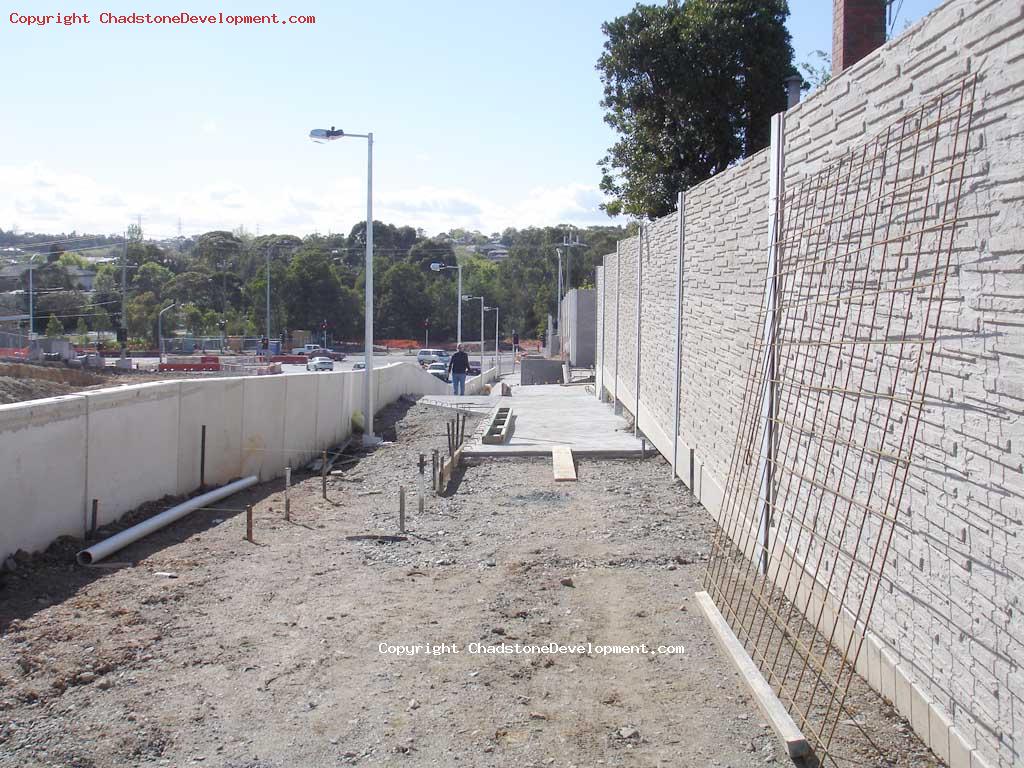 Steel mesh leaning on wall on the un-concreted part of footpath - Chadstone Development Discussions